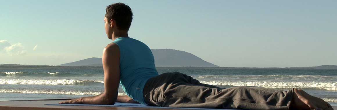 Dru Yoga sphinx posture, beach