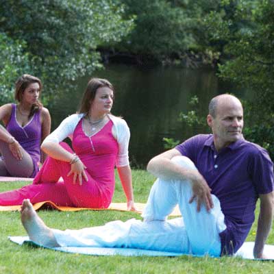 Christiane and Dru Yogis - sitting twist by river